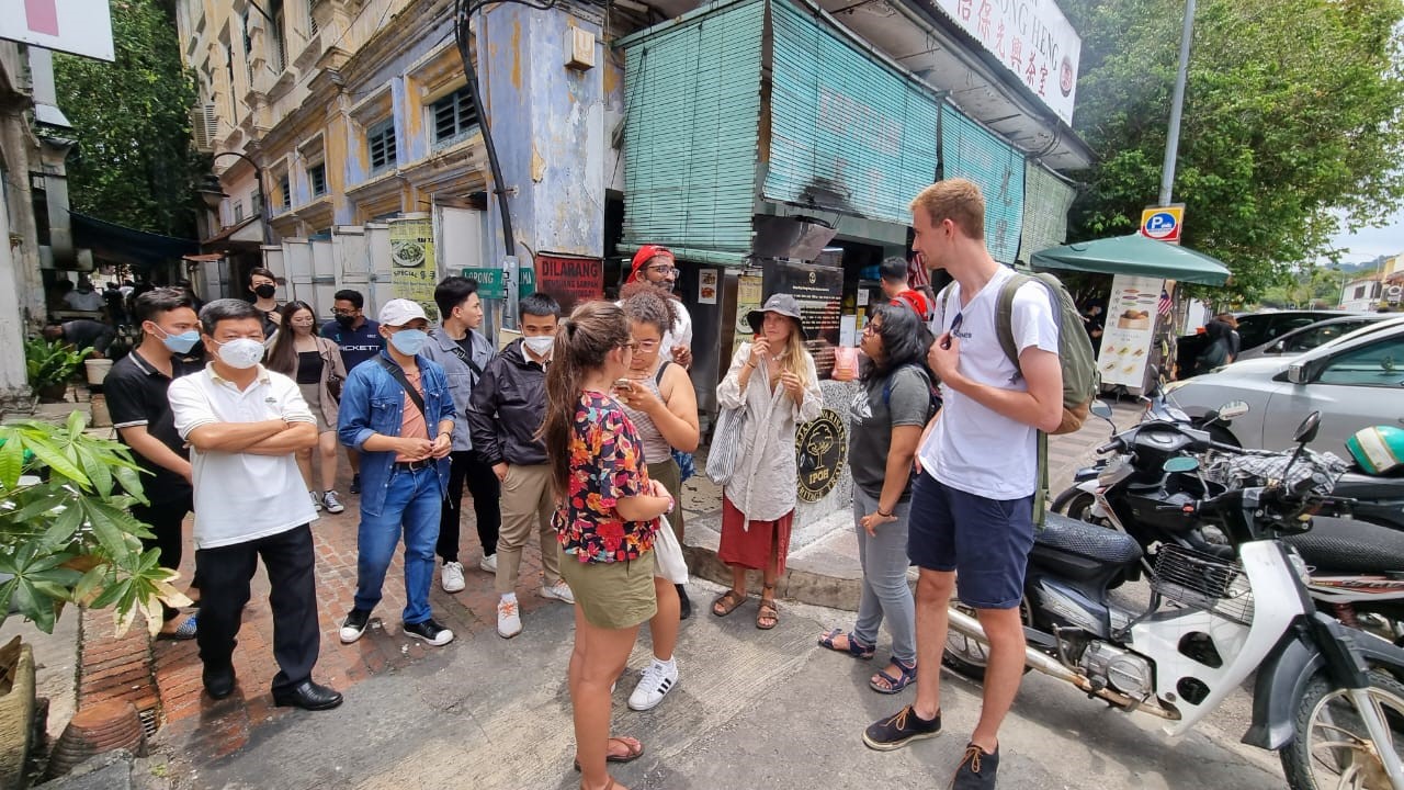 A group of people standing in a street Description automatically generated with low confidence